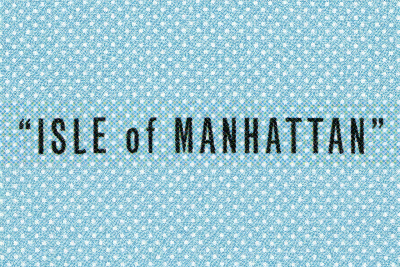 Isle of Manhattan in dark condensed lettering over a pale blue-and-white geometric pattern.