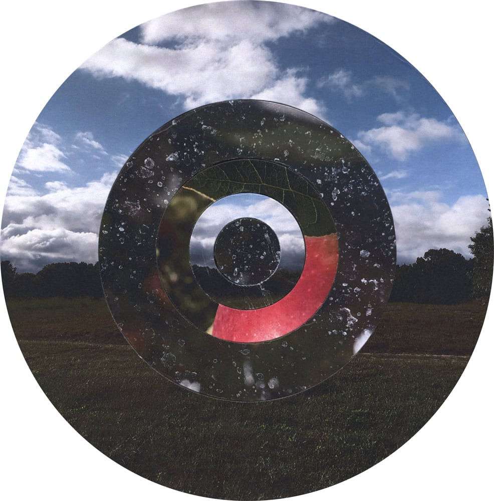 Circular collage of blue sky and dark landscape textures with concentric rings and a small red segment.