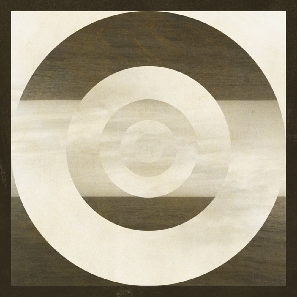 Cream and brown concentric photographic rings over a square landscape texture, with a pale horizontal band through the center.
