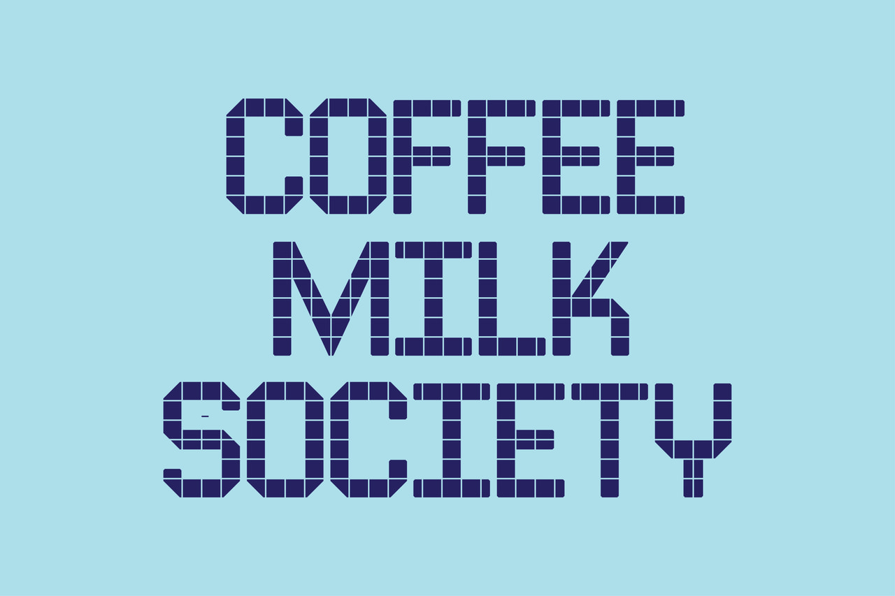 Coffee milk society, in three lines of dark purple tile lettering on pale cyan.