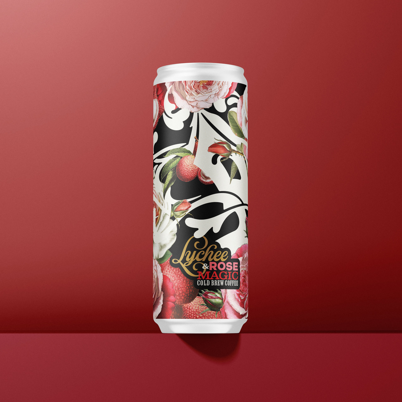 Slim Lychee Rose Magic cold-brew can with pink flowers, fruit and black-and-white ornamental artwork, on burgundy.