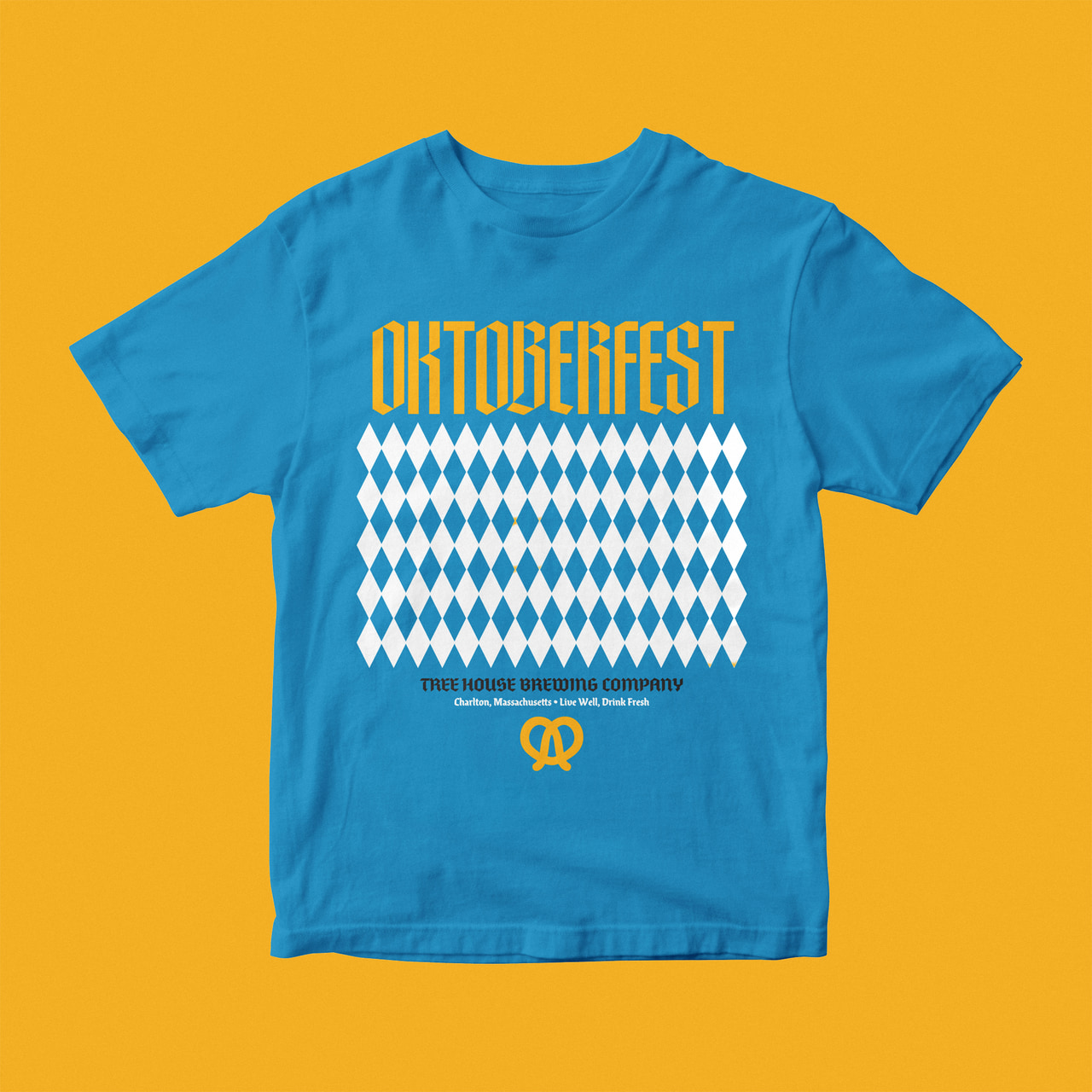 Blue Oktoberfest T-shirt with yellow lettering above white diamond patterns and a yellow pretzel ornament, on yellow.