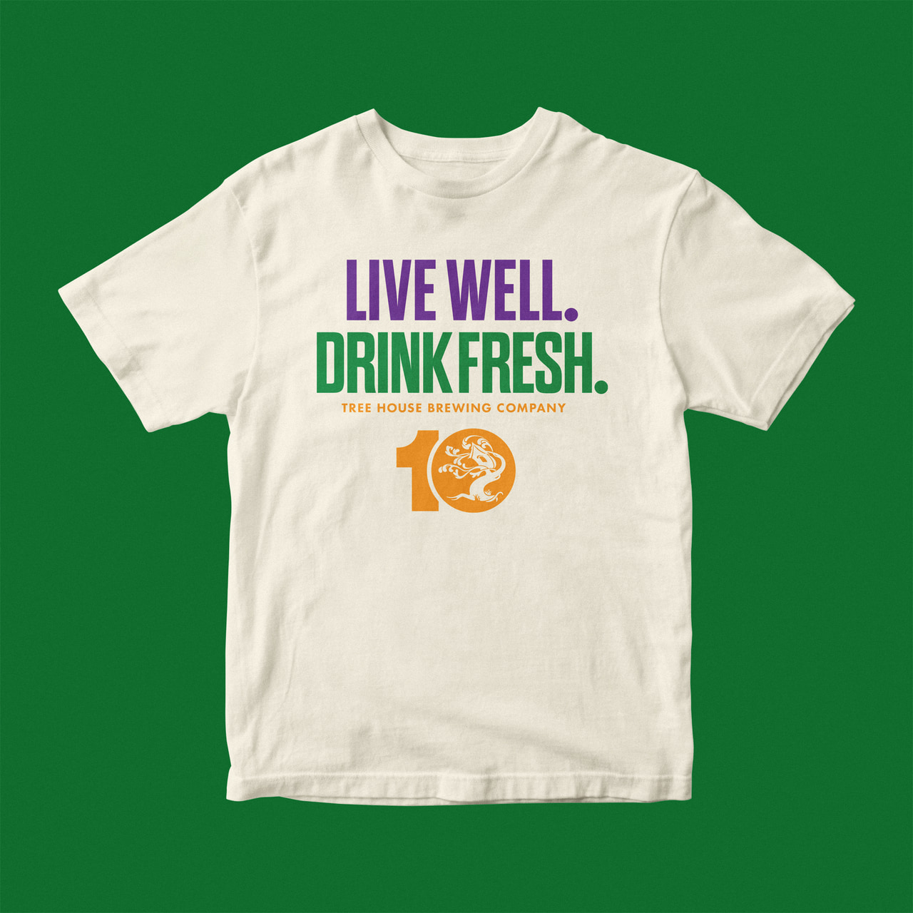 White T-shirt reading Live well. Drink fresh. in purple and green above an orange 10-year ornamental-tree mark, on green.