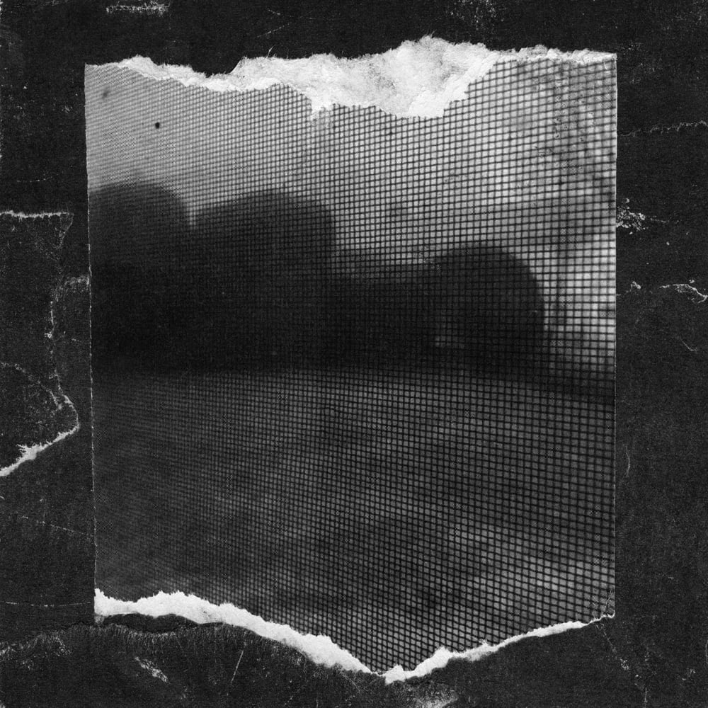 Torn rectangular photograph of a blurred halftone landscape on a dark textured background.