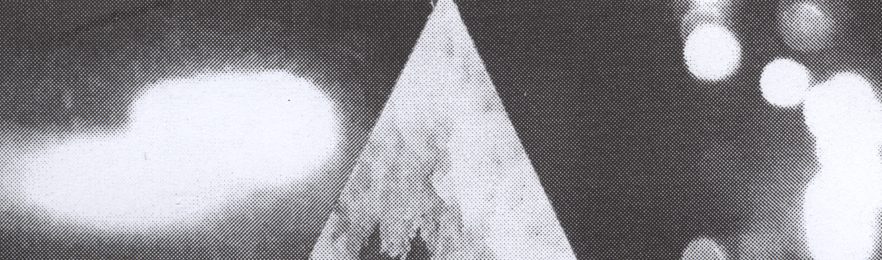 A monochrome photographic strip with a pointed form amid soft lights and halftone dots.