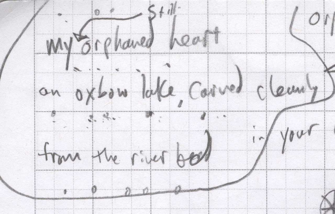 Circled handwritten poem draft on graph paper: My still orphaned heart, an oxbow lake carved cleanly from the riverbed.