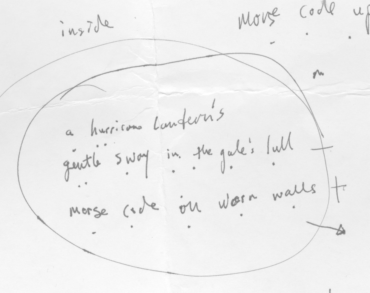 Circled handwritten poem draft with revisions: A hurricane lantern's gentle sway in the gale's lull; Morse code on worn walls.