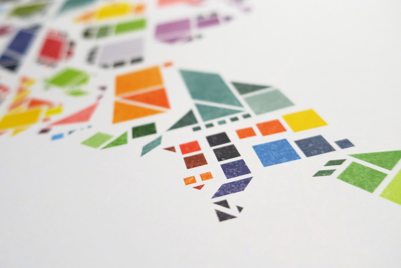 Close-up of a Tangram States print, with states assembled from brightly colored geometric pieces.