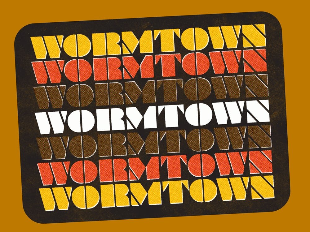 Wormtown repeated in seven rows of geometric lettering, colored yellow, orange, brown and white on a mustard background.